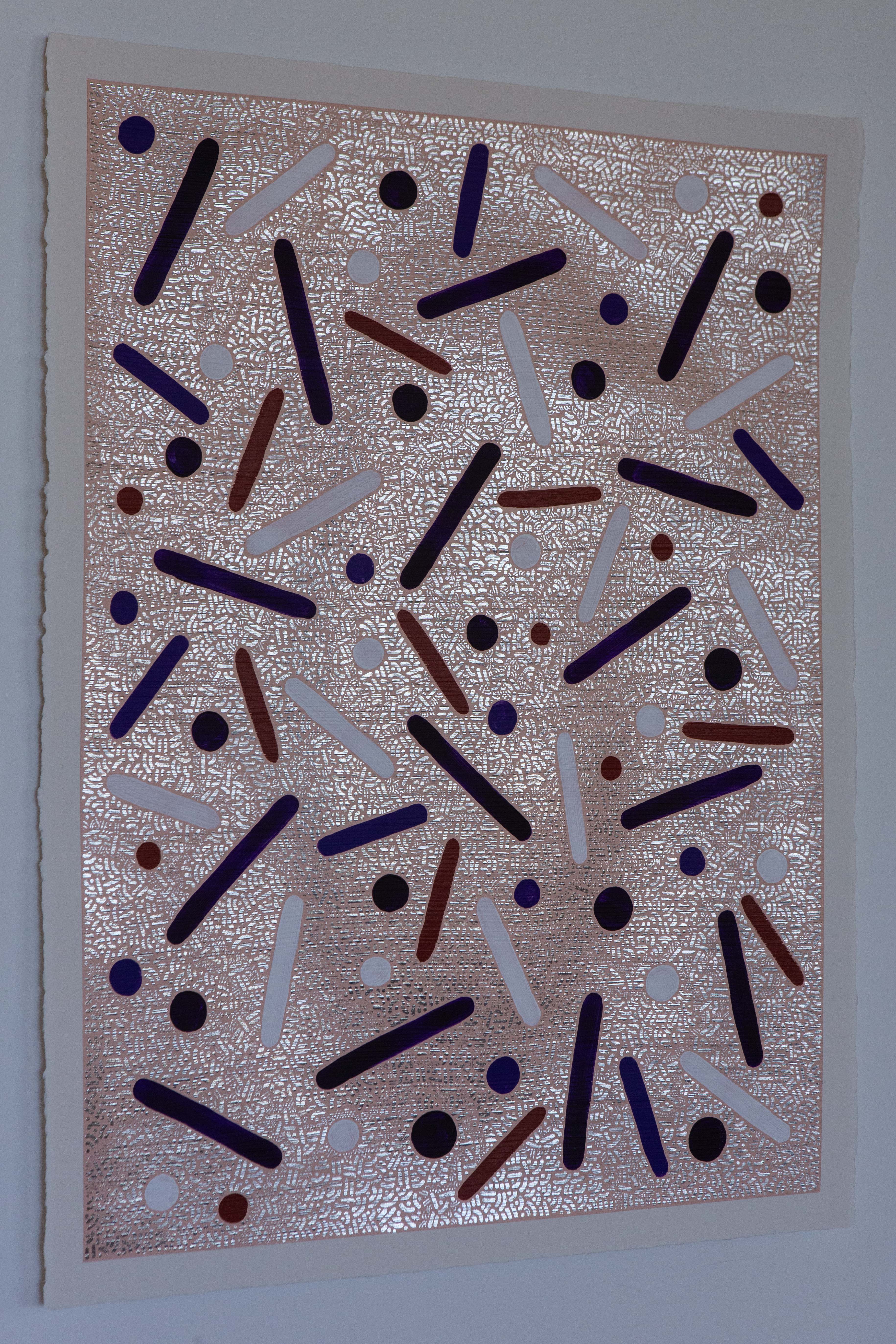 Angled view of Desert Bloom by Pipe Yanguas on white backing, showing indigo, white and earthy red marks over a detailed silver field.