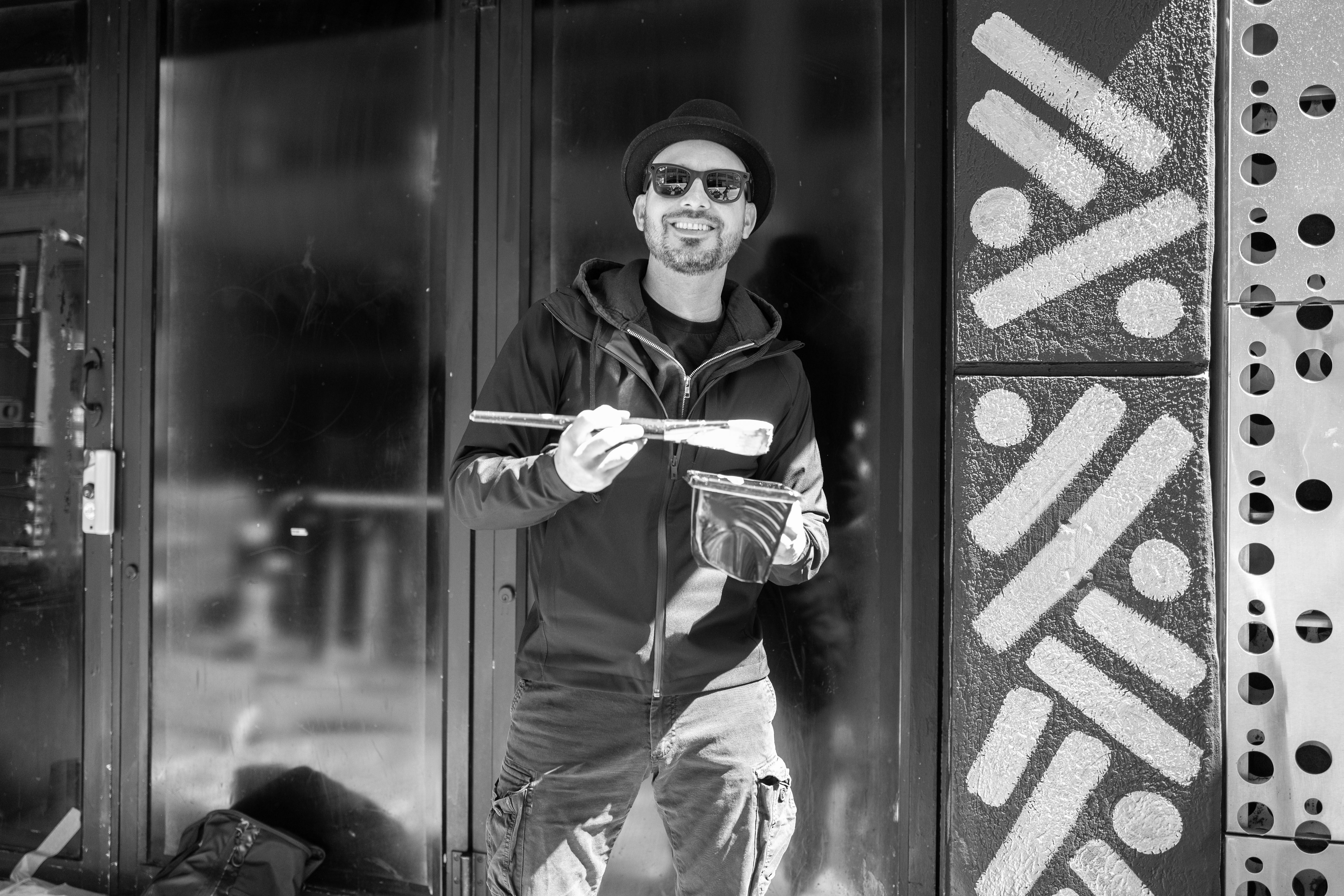 The Golden Weave: Black-and-white portrait of a person at a doorway beside patterned dots and lines.